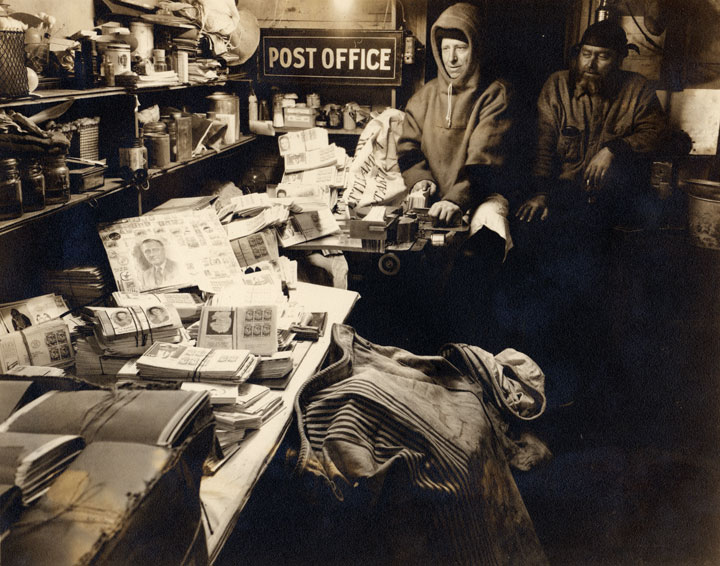 Charles Anderson canceling the mail at the Little America Post Office, 1935.