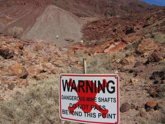 Mines in the Calico area are extremely hazardous and must not be approached for any reason. A sign warning people to stay away from a dangerous area of mines and waste-rock piles in Calico Ghost Town, California. source