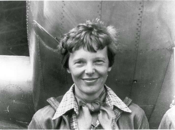 Amelia Earhart in front of an airplane in the 1930s