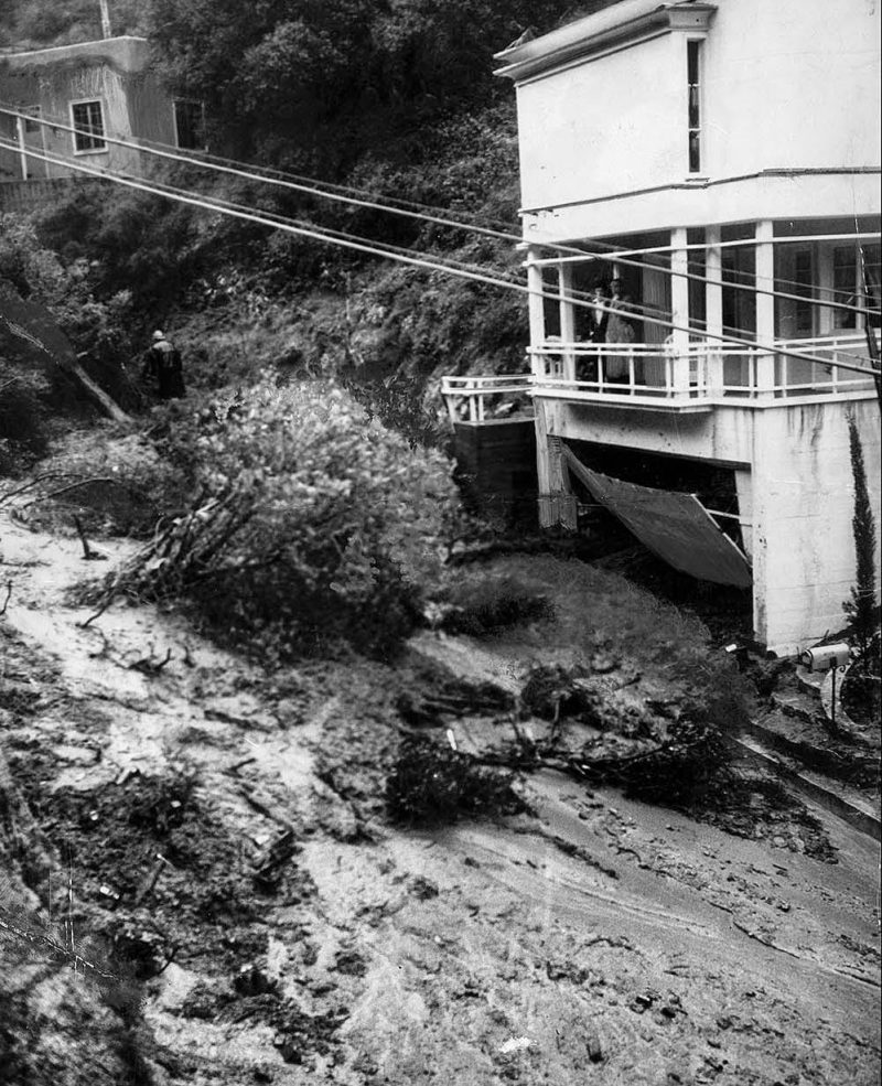 March 2, 1938 Water-soaked earth moved rapidly down the side of Laurel Canyon at Kirkwood Avenue, carrying trees and boulders in its path and wrecking the basement garage of this home.