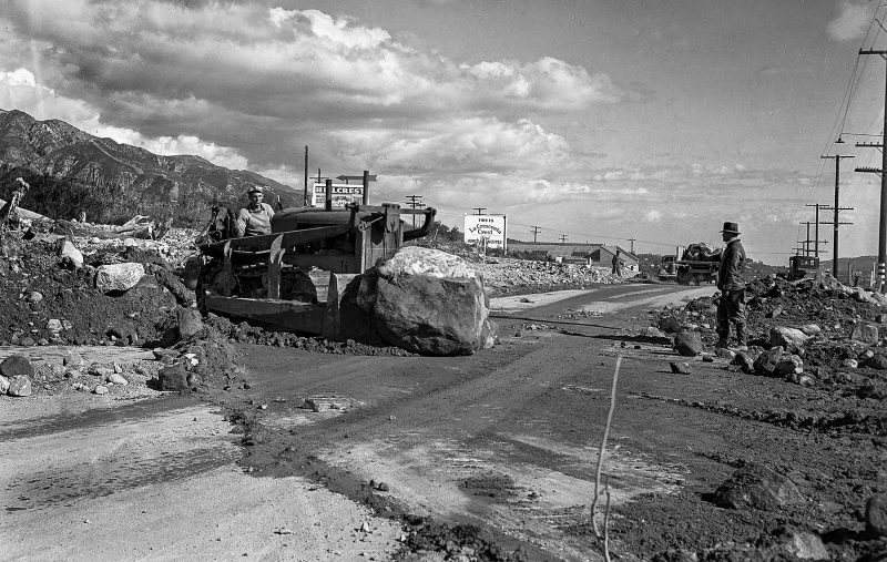 March 4, 1938 A road crew removes debris from Foothill Boulevard at Lowell Street near Tujunga.