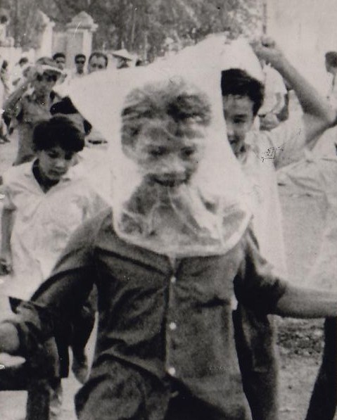 Protection from gas vomiting improvised plastic masks, Saigon,South Vietnam, 1966