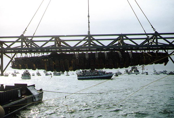 The H. L. Hunley, suspended from a crane during its recovery from off of Charleston Harbor, August 8, 2000. (Photograph from the U.S. Naval Historical Center.)