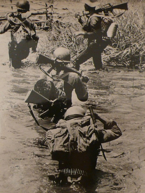 US Soldiers carrying packs, Saigon, 1969