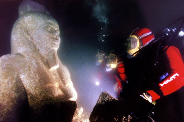 Three divers inspect the ancient colossal statue of the God Hapi in this undated photo. Statues, sunken ships, gold coins and jewelry are among the submerged treasures that French Marine archaeologist Franck Goddio has uncovered in the ancient submerged city of Heracleion off the coast of Alexandria June 7, 2001. source