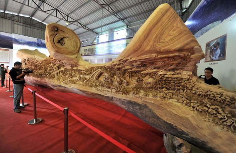 A giant masterpiece has been recorded as the longest one piece wood carving in the world. And the time it took to get it officially recognised is also almost a record - after the exhibition hall where it is housed revealed it was actually crafted in Fujian province in southeast China nearly 1,000 years ago. Called "Riverside Scene at Qingming Festival", it has only now been recognised by the Guinness Book of World Records as the largest single piece wood carving in the world. The work measure 12.286 meters long, and at the highest point is 3.075 meters. It is also 2.401 meters wide. It took artist Zheng Chunhui four years to complete and currently is stored at the Palace Museum in Beijing where it is recognised as a national treasure. A museum spokesman said: "He was a master craftsman but sadly this is the only piece of his work to have survived. But nevertheless it is a remarkable piece. "It gives a 3D snapshot of a period in the life of daily life of people of all ranks in the capital city of Bianjing (today's Kaifeng, Henan Province) during Qingming Festival in the Northern Song Dynasty. As such it is also a valuable historical witness, bringing the period to life in a way that a book or scroll never could. "It's the next best thing to experiencing it in real life, showing rich and poor about their daily business. In fact there are 550 people in the carving."