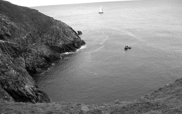 A view of the wreck site from the top of Lambay's cliffs. The small boat is tethered to what remains of RMS Tayleur 