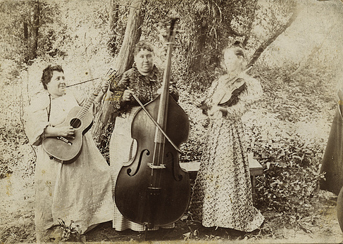 hree women playing guitar, cello, and violin in southern Ohio