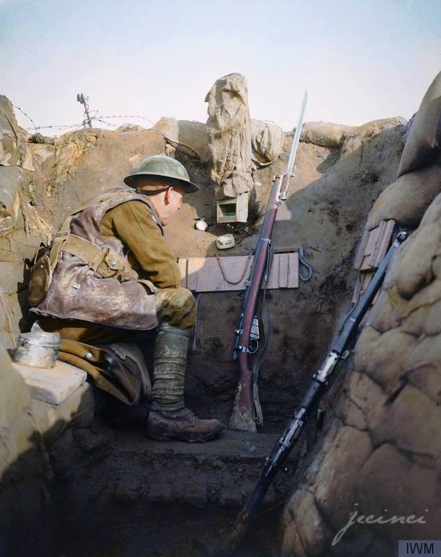 A Sentry of the 1/4th Battalion, East Lancashire Regiment in a sap-head at Givenchy-lès-la-Bassée, Pas-de-Calais, France, 28 January 1918. Note a camouflaged periscope. A 'Listening Post' also commonly referred to as a 'sap-head', was a shallow, narrow, often disguised position somewhat in advance of the front trench line - that is, in No Man's Land. 1/4th Battalion August 1914 : in Blackburn. Part of East Lancashire Brigade in East Lancashire Division. Moved on mobilisation to Chesham Fold Camp (Bury) but sailed on 10 September 1914 from Southampton for Egypt. 26 May 1915 : formation became 126th Brigade, 42nd (East Lancashire) Division. 14 February 1918 : transferred to 198th Brigade in 66th (2nd East Lancashire) Division, and absorbed 2/4th Bn. Renamed 4th Bn. 7 April 1918 : reduced to cadre strength. 16 August 1918 : transferred to 118th Brigade in 39th Division on Lines of Communication work. (Photo source - © IWM Q 6473) Photographer - Lt. John Warwick Brooke (Colorised by Paul Kerestes from Romania) https://www.facebook.com/jecinci/
