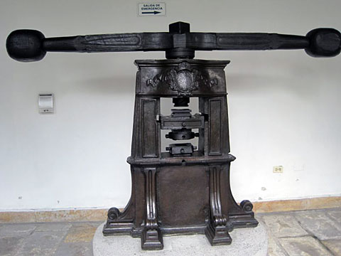A Screw press. Hammered coins are produced by hand, whereas milled coins are produced by a machine