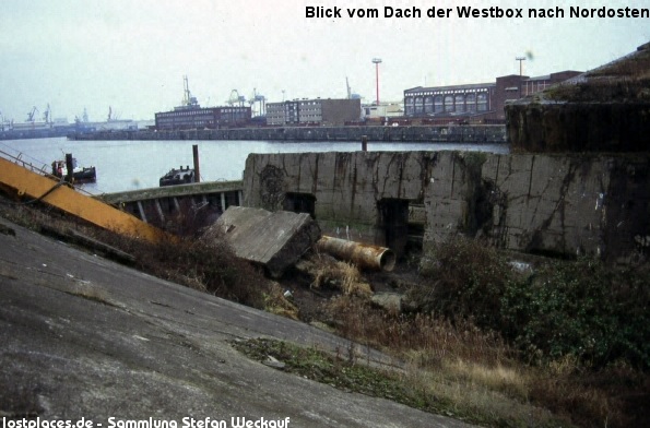 The area is within the freeport of Hamburg but in recent years the whole area has been filled over and the remains of the base and the trapped boats are now beneath a car park. source