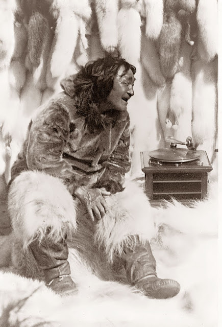 An Eskimo man enjoying some music on a record player, 1922