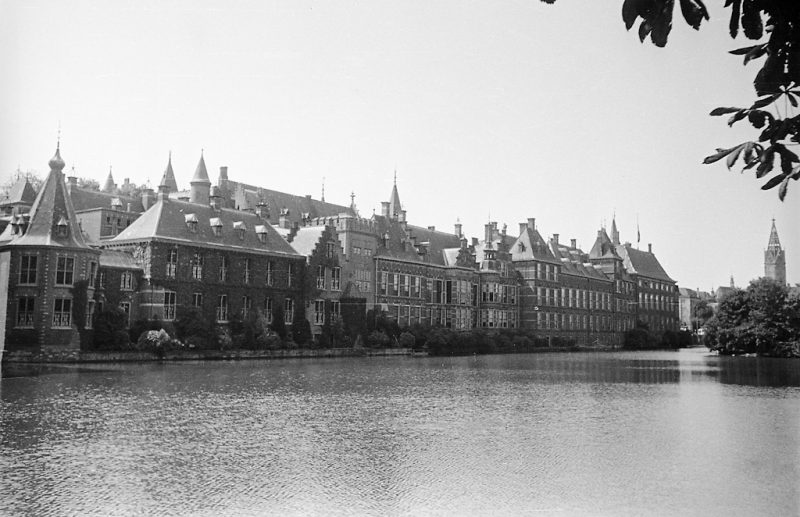 Binnenhof parliament offices at Hofvijver pond in The Hague. The small tower to the left (Torentje) is today the office of the Dutch Prime Minister. The church Grote Kerk far to the right