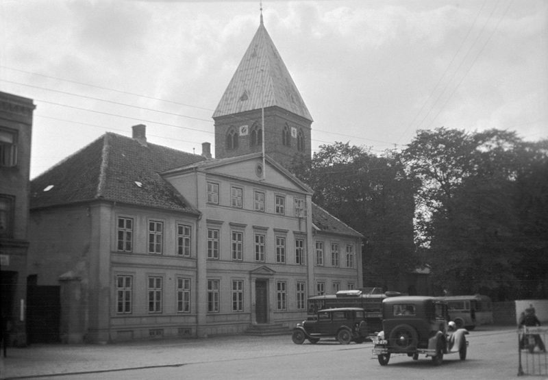 Cars, a house and the tower of St. Bendt's church (inaugurated in 1170, then a monastery church) in Ringsted