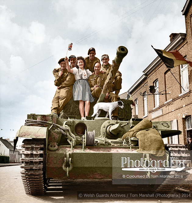 No. 2 Squadron Welsh Guards during the liberation of Brussels on 3rd September 1944. Shows (L to R) SgtT. E. Williams, LCpl R. Gibson, a Belgian girl,