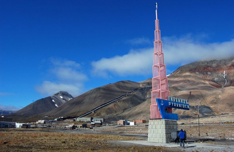 The monument of Pyramiden, with the last ton of coal extracted from the mine behind it.Wikipedia