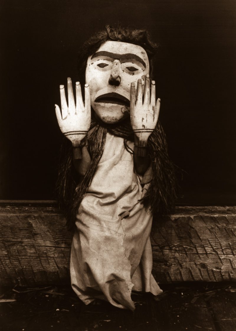 A Kwakiutl person dressed as a forest spirit, Nuhlimkilaka, ('bringer of confusion').1914