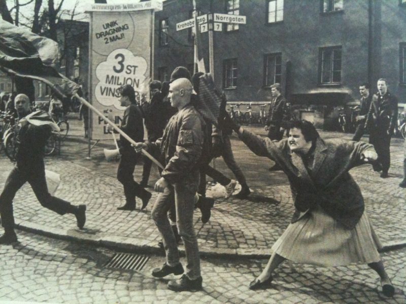 A Swedish woman hitting a neo-Nazi protester with her handbag. The woman was reportedly a concentration camp survivor. [1985] source