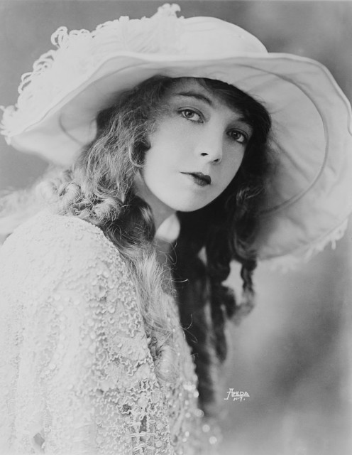 Gish wearing a white dress and a hat
