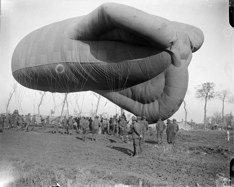 Battle of Broodseinde. A Caquot kite balloon after being hauled down by its winch. Note air mechanics hauling on ropes to keep the basket on the ground. Near Ypres, 5 October 1917. source
