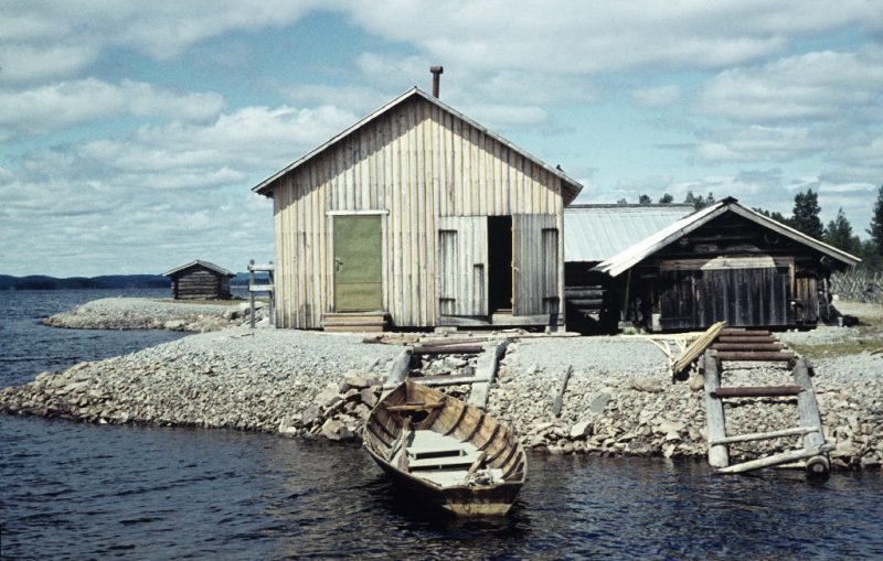 Boathouses and a boat, at Tisjölandet by lake Tisjön in Dalecarlia. Taken in 1958