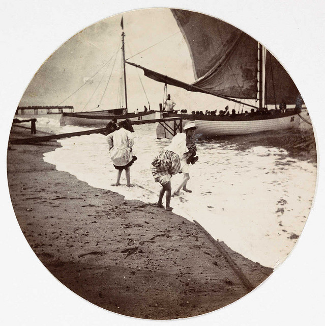 Children paddling in the sea, about 1890