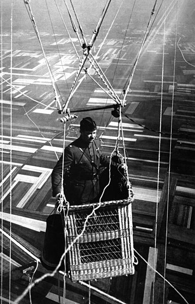 Close-up view of an American major in the basket of an observation balloon flying over territory near front lines, 1918. source