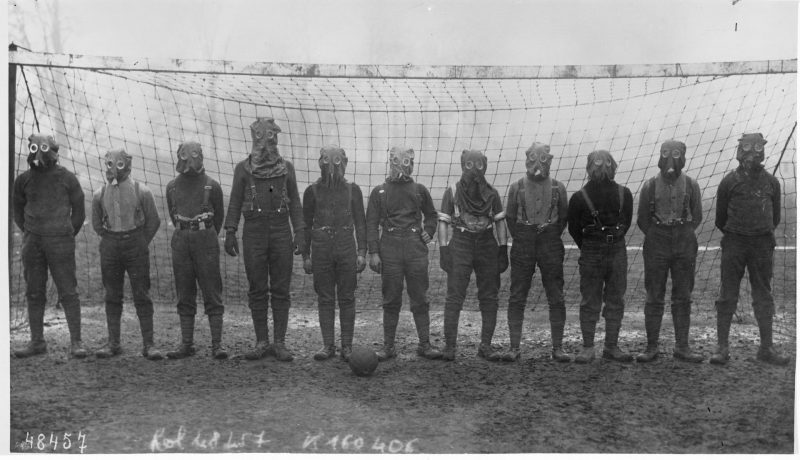 Football team of British soldiers with gas masks, Western front, 1916.Source