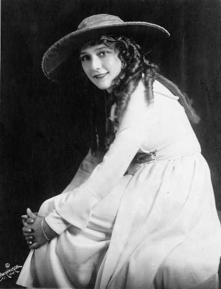 Mary Pickford, three-quarter length portrait, seated, facing left .Source
