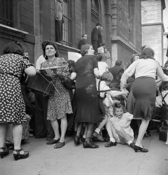 Parisian mothers shield their children from German sniper fire. [1944]
