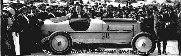 Ralph DePalma and his Packard V-12 in a crowd at Daytona in 1919. source