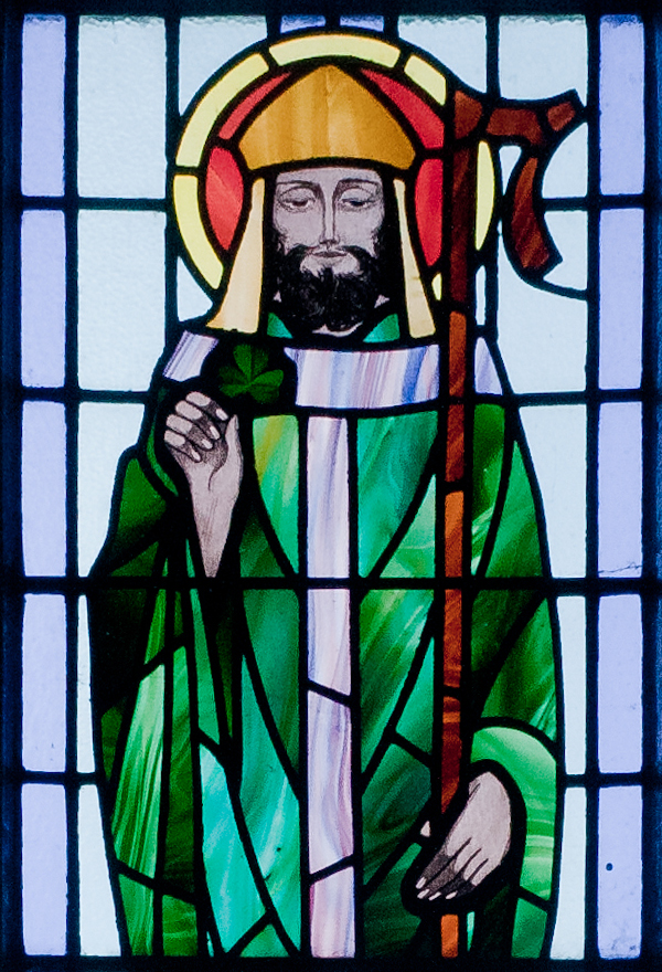 St. Patrick depicted with shamrock in detail of stained glass window in St. Benin's Church, Kilbennan, County Galway, Ireland
