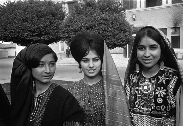 Three Afghan women standing outside