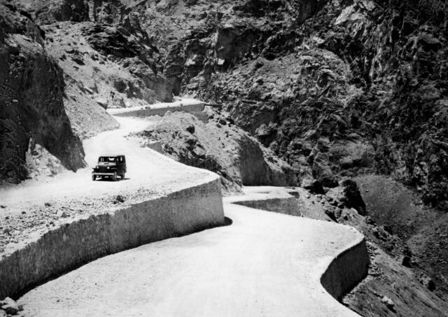 Car driving along a mountainside road