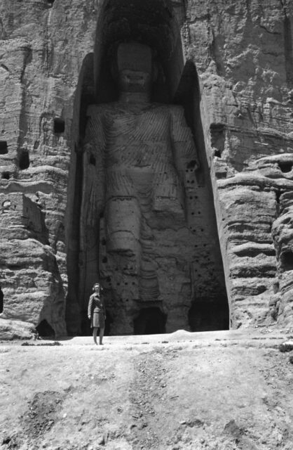 Woman standing beneath one of the Buddhas of Bamiyan