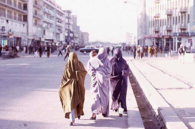 Three women walking along a street in Kabul, Afghanistan