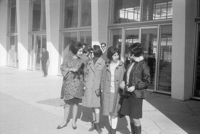 Four women standing outside the entrance of Kabul International Airport