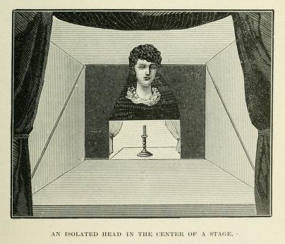 An isolated head in the center of a stage