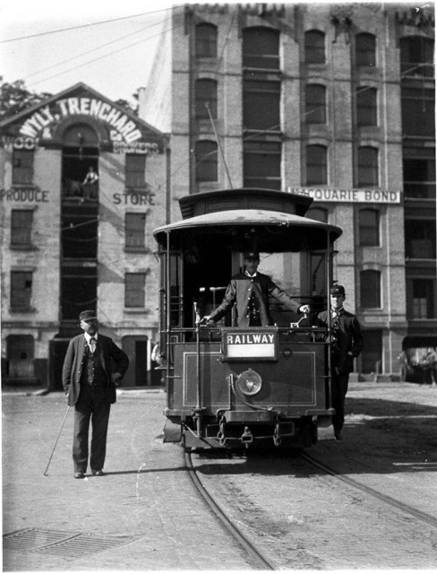 "Railway" (Central Station) tram, Wyly. Trenchard Produce Store and Macquarie Bond Store, Circular Quay, c.1898 / by Albert James Perier.