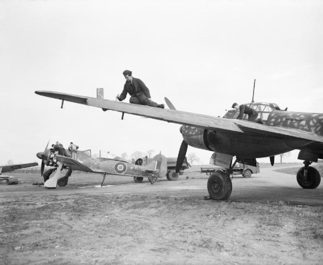 Captured German aircraft of No. 1426 (Enemy Aircraft Circus) Flight at Collyweston, Northamptonshire, undergoing maintenance; Focke Wulf Fw 190A-3, PN999, undergoes an engine service while airmen re-paint the wings of Junkers JU 88S-1, TS472. source