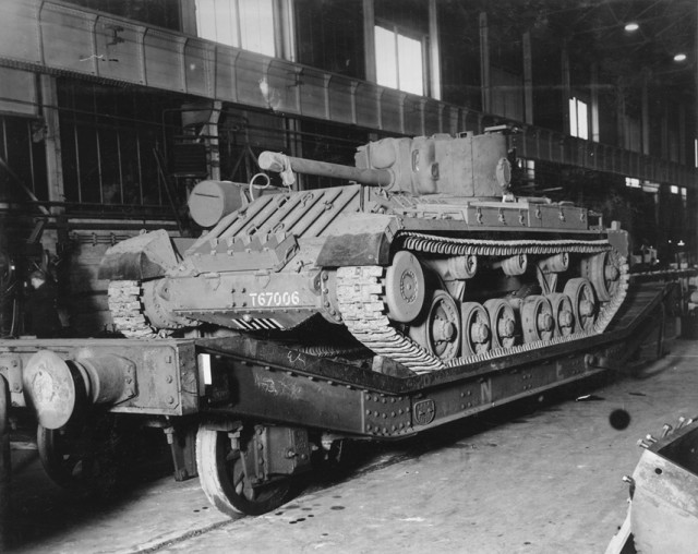 A 6-pdr. Valentine Tank on a truck ready for delivery, inside the Tank Shop.