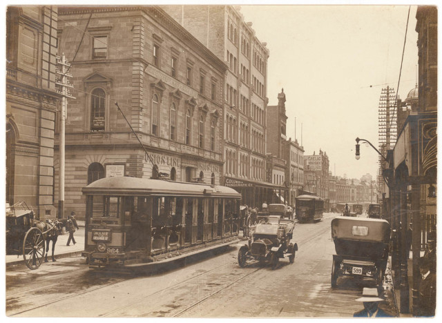 [Looking north along George Street (with tram, T-model Ford and hansom cab) from Union Line Building (incorporating the Bjelke-Petersen School of Physical culture), corner Jamieson Street], n.d. by Sam Hood.