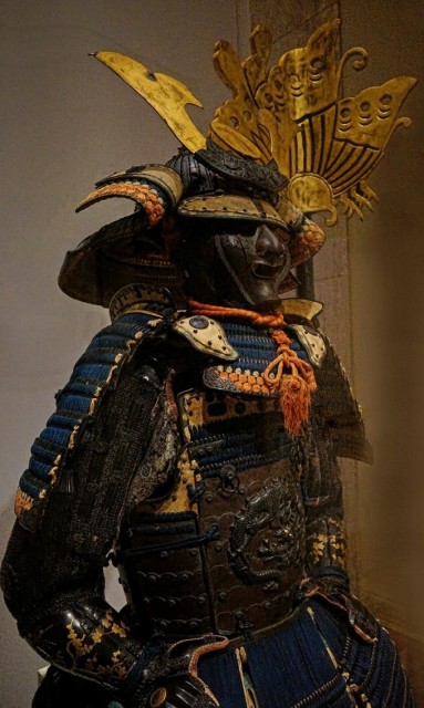 View of the upper torso of the Yokohagidō Armor with shakudō cuirass crafted from an alloy of copper and gold depicting a coiled dragon Helmet 14th century CE Armor 18th century CE Japan.