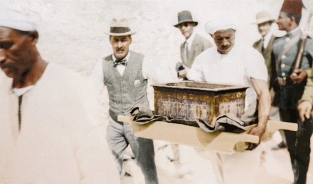 At Thebes, Howard Carter escorts an ornamental gilt and inlaid casket to the workroom.