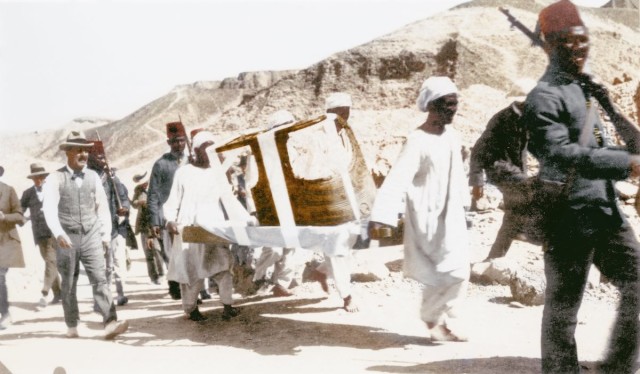 Howard Carter (on the left) accompanies the body of one of Tutankhamun's chariots to the workroom.