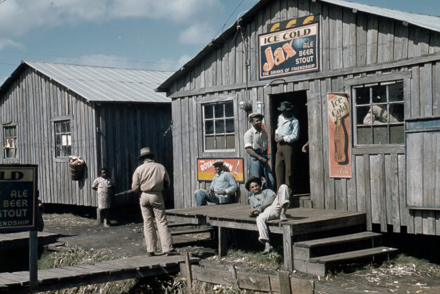 Migrant workers congregate outside a juke joint during a slack season in Belle Glade, Florida.