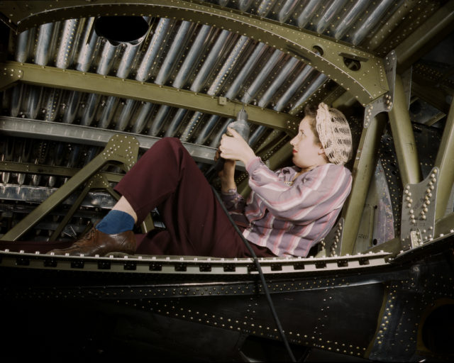 A Douglas Aircraft Company worker rivets an A-20 bomber at the plant in Long Beach, California.