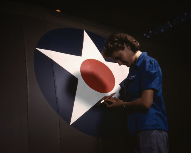 A Vultee Aircraft employee touches up the U.S. Army Air Forces insignia on the fuselage of a Vengeance dive bomber at the plant in Nashville, Tennessee.