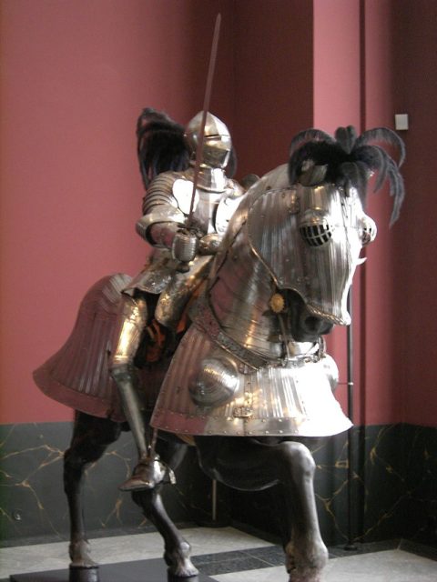 A sixteenth-century knight with a horse in full barding. Source