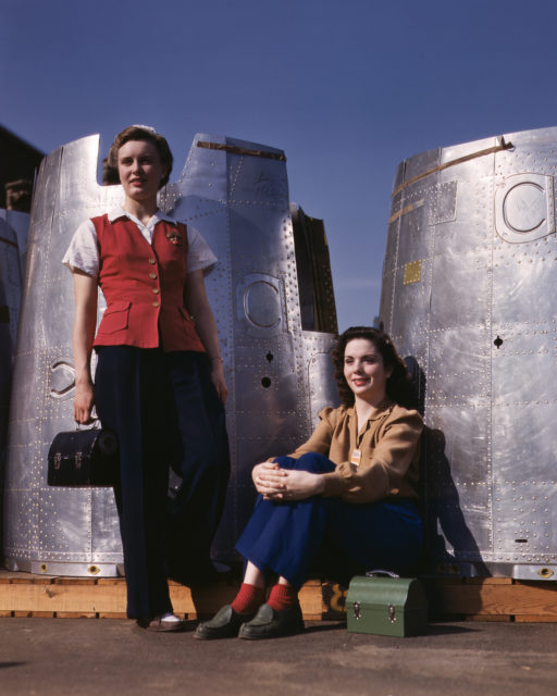 Two assembly workers take a lunch break next to heavy bomber nacelle parts at the Douglas Aircraft Company plant in Long Beach, California.